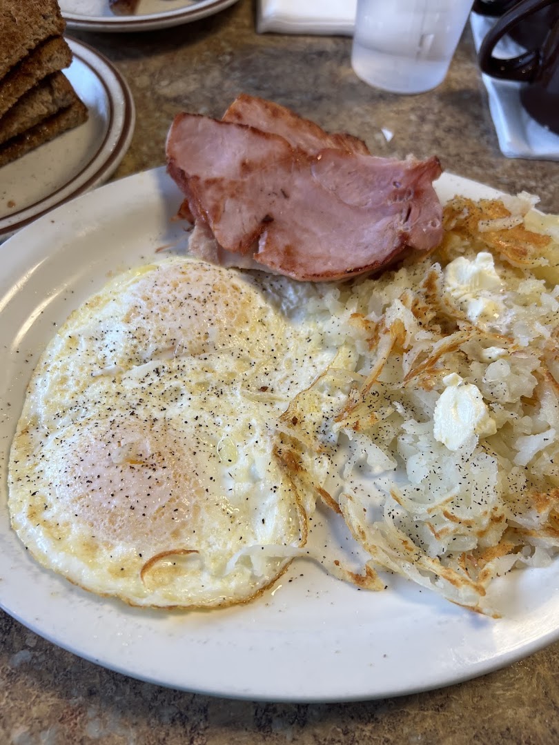 Grilled ham with over-easy eggs and fresh-shredded hash browns