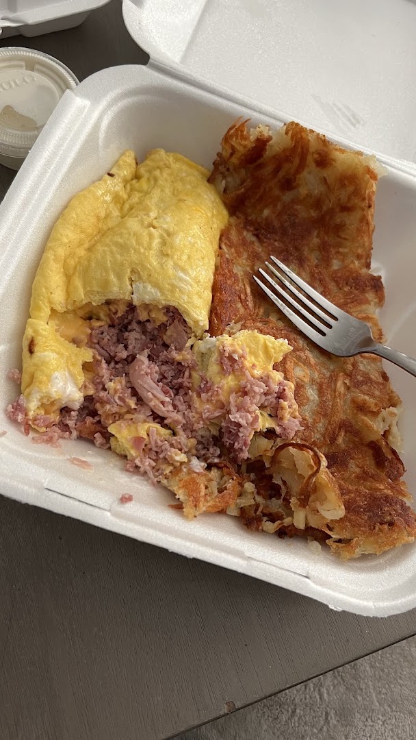 A ham and cheese omelette with a generous side of crisp hash browns